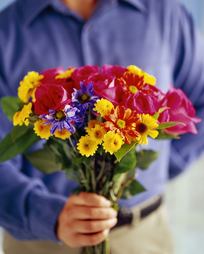 Guy giving flowers