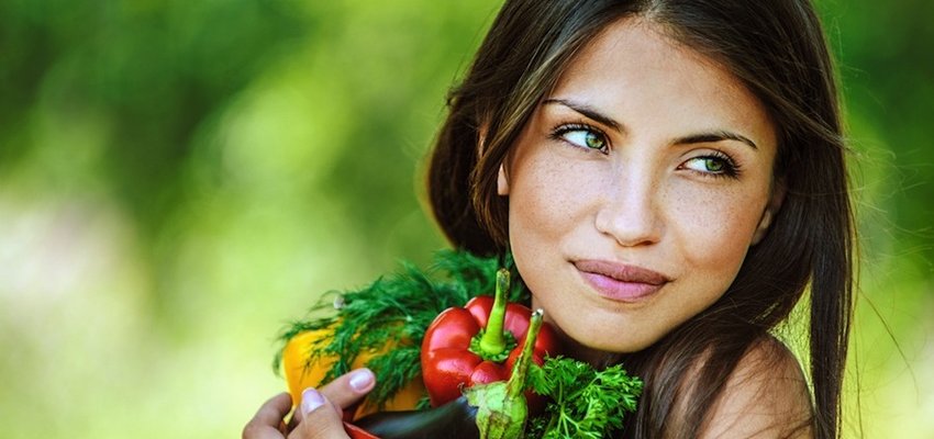 Woman holding vegetables