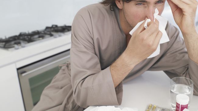 A man wiping his nose