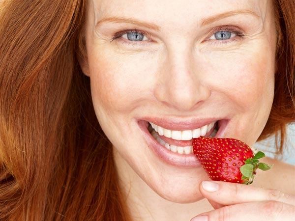 woman eating strawberry