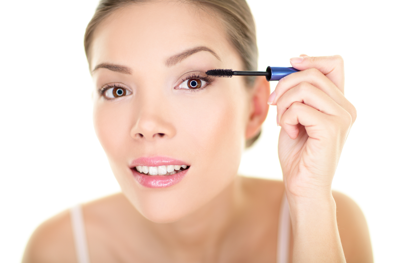 Woman curling eyelashes